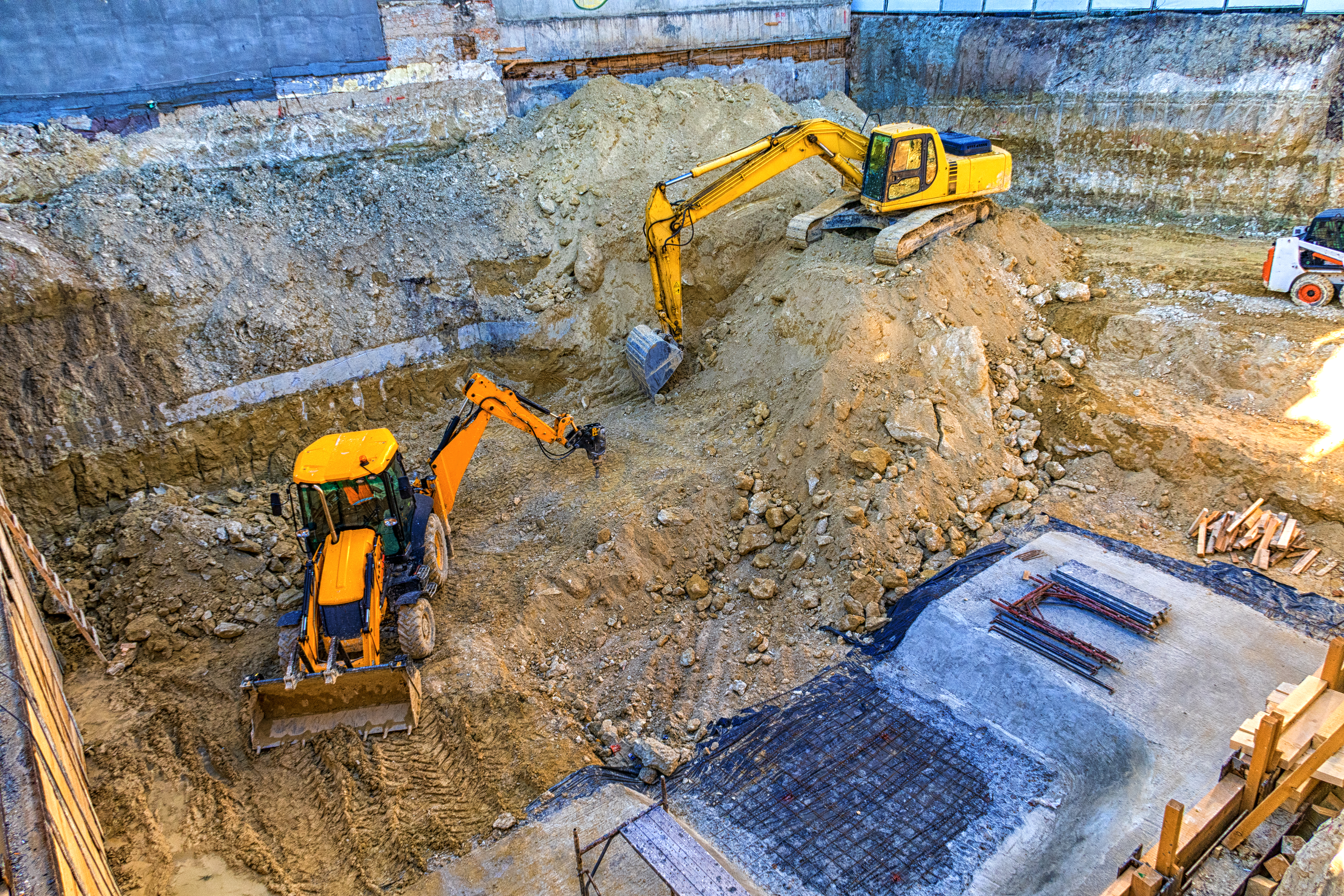 Two yellow diggers in a dug out quarry